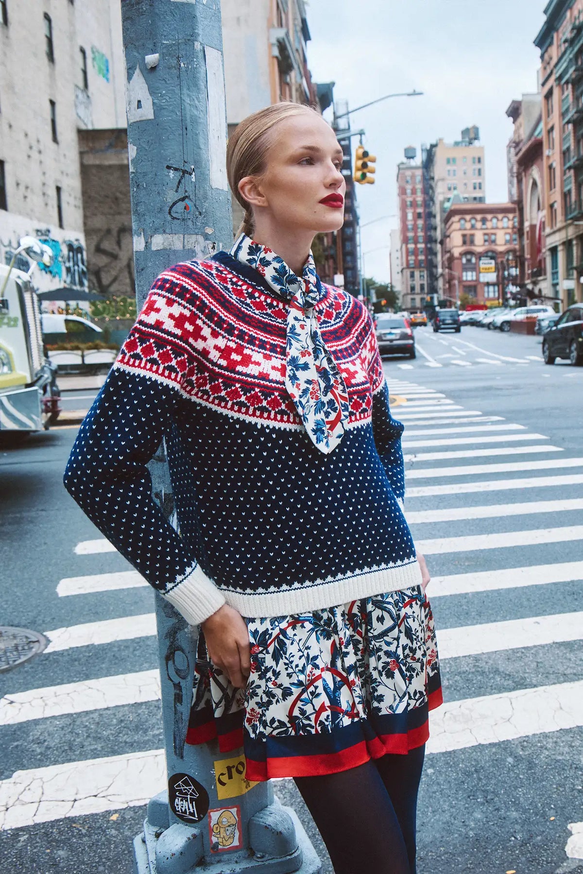 The Lila Dress is a mini with a tie neckline, long sleeves with button cuffs and a color block hem. 