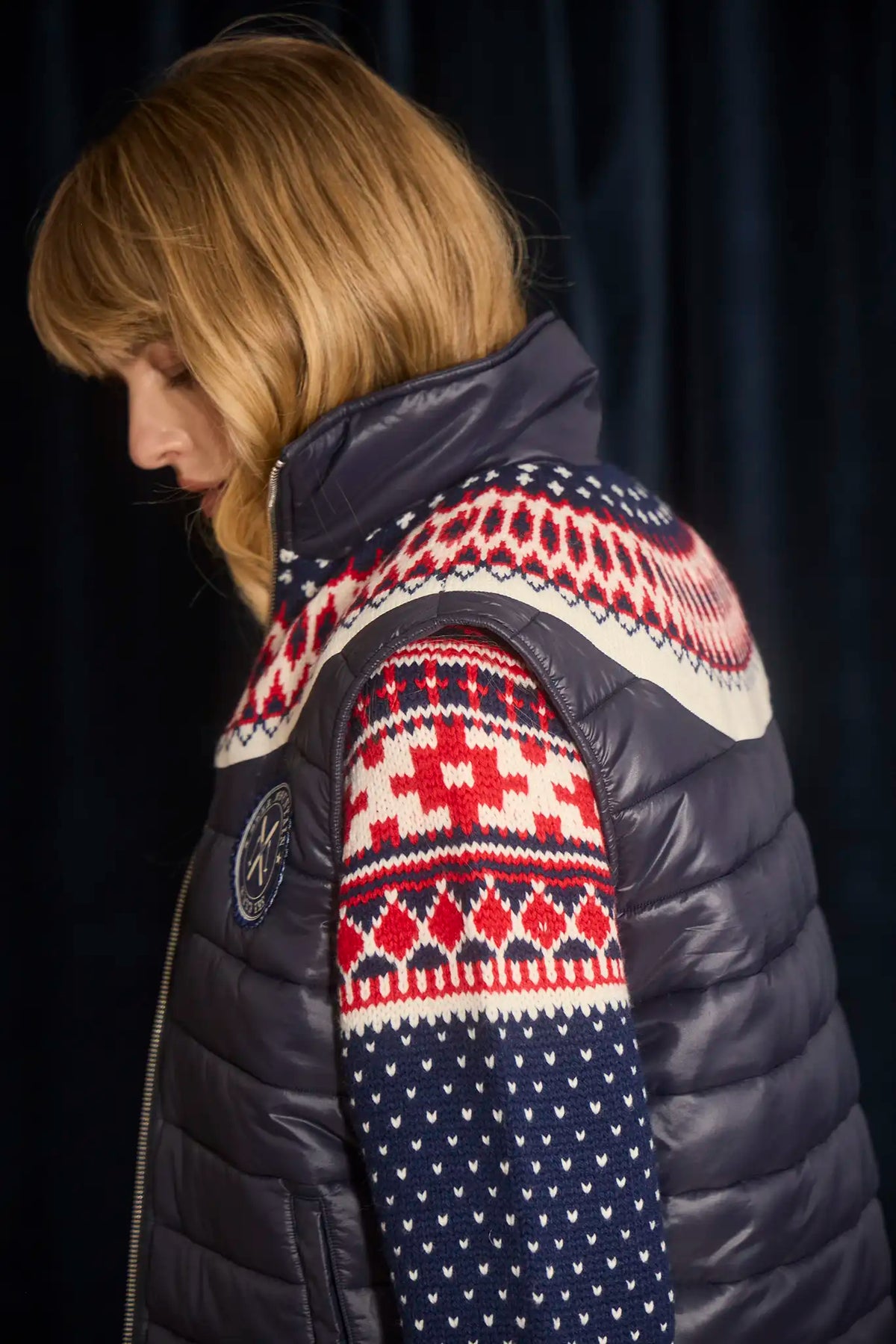 The Brady Vest is a elevated puffer with a collared neckline and a knitted Fair Isle yoke.