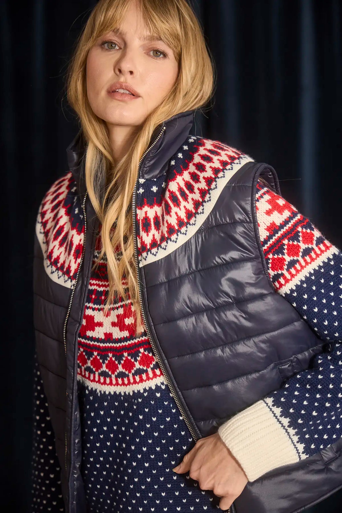 The Brady Vest is a elevated puffer with a collared neckline and a knitted Fair Isle yoke.