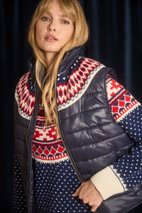 The Brady Vest is a elevated puffer with a collared neckline and a knitted Fair Isle yoke.
