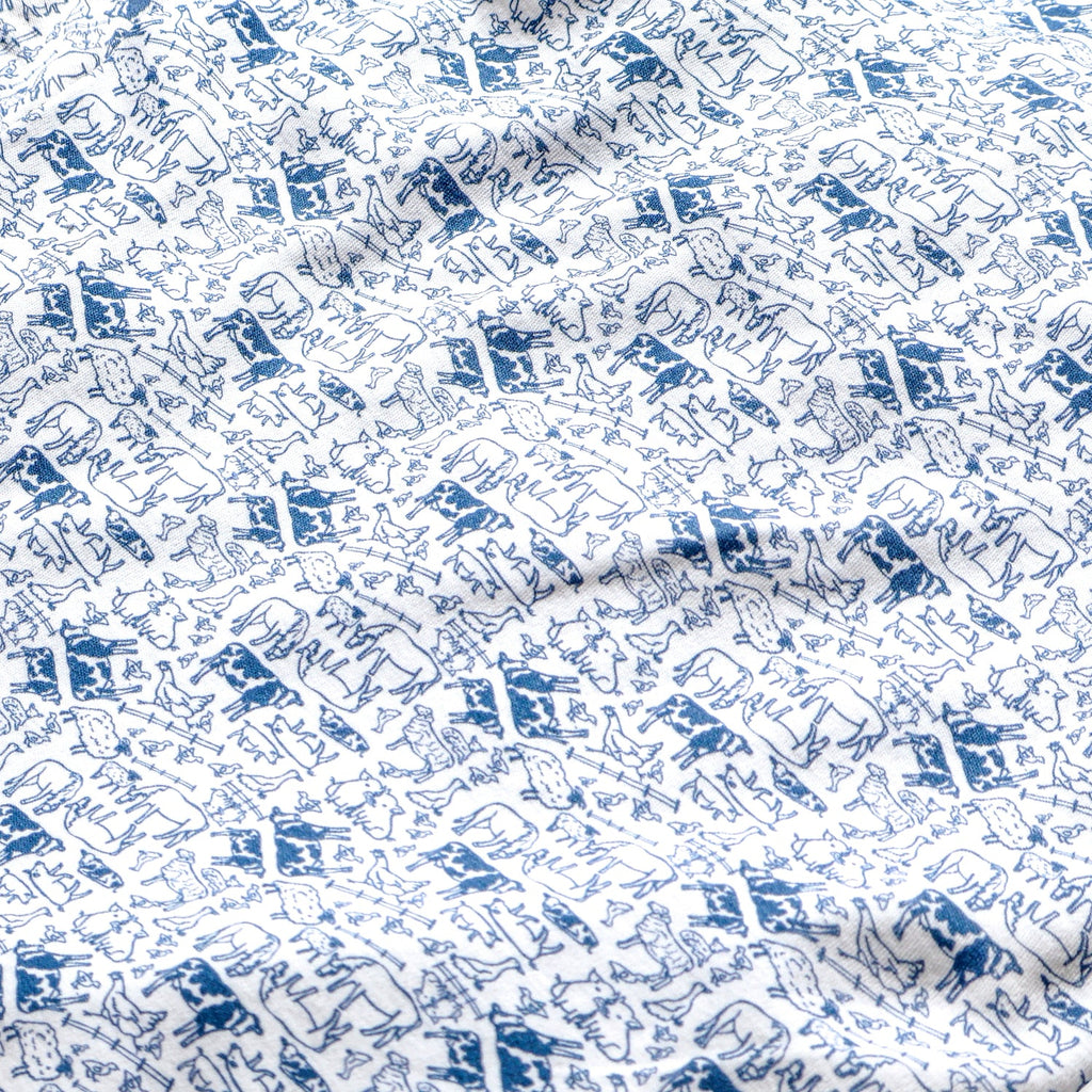 Close-up of Farm Kids Henley Pajamas, Set of 2 showcasing blue farm-themed print on white fabric