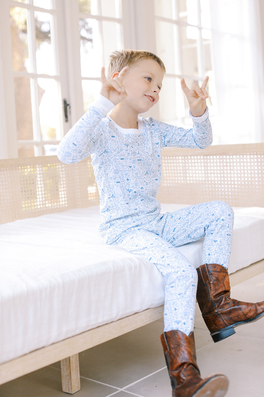 Boy in Dallas Fort-Worth Pajamas & cowboy boots