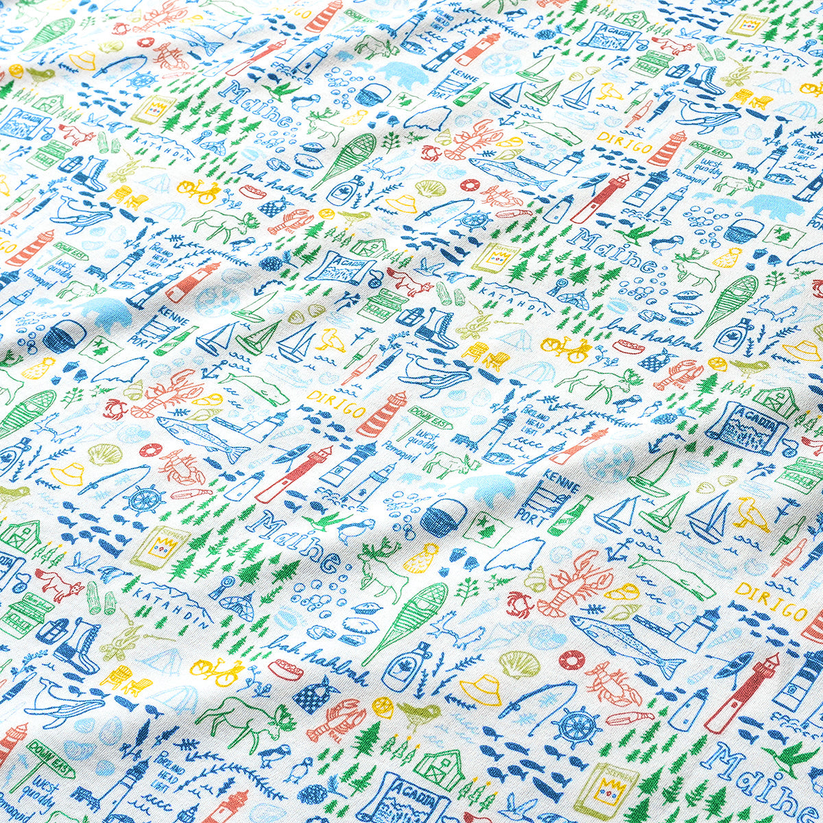 Close-up of Maine two-piece kids pajamas showcasing a colorful illustrated print on white fabric