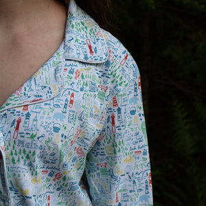 Close-up view of Maine women’s button-front long pajama set showcasing collared neckline and hand-drawn Maine print against dark background