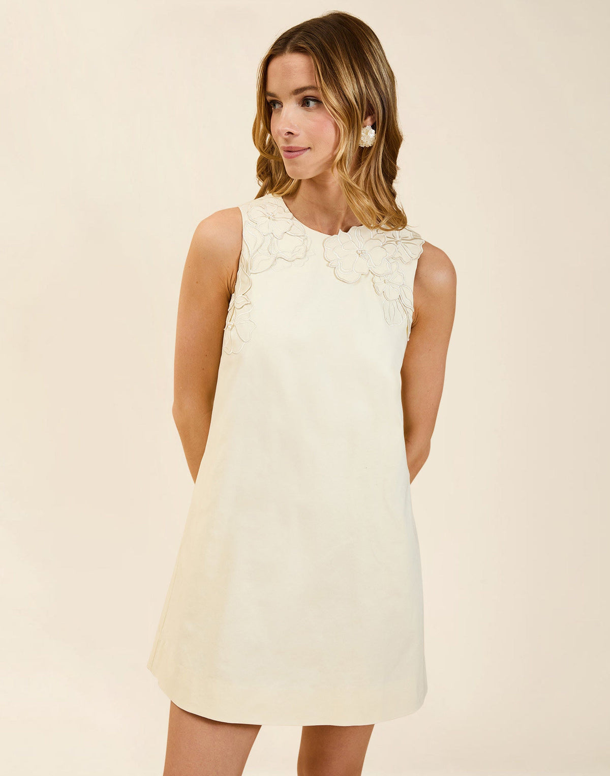 Juniper Shift Mini Dress in Ivory cotton poplin with 3D floral embroidered appliqué, sleeveless shift silhouette, crew neckline, and hidden pockets.