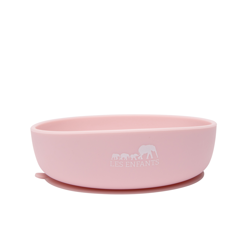 Front view of pink silicone baby bowl showcasing suction base with quick-release tab on white background