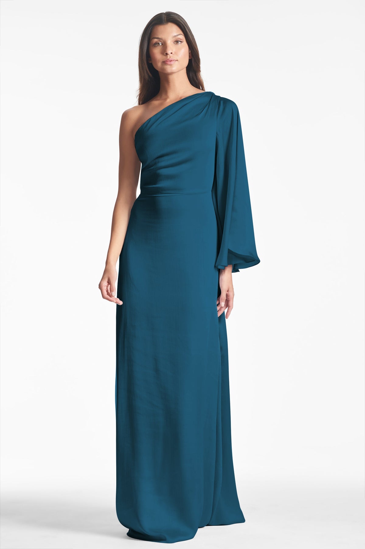Front view of Keely Gown in Bottle Green showcasing its one-shoulder design and long draped sleeve against a white background