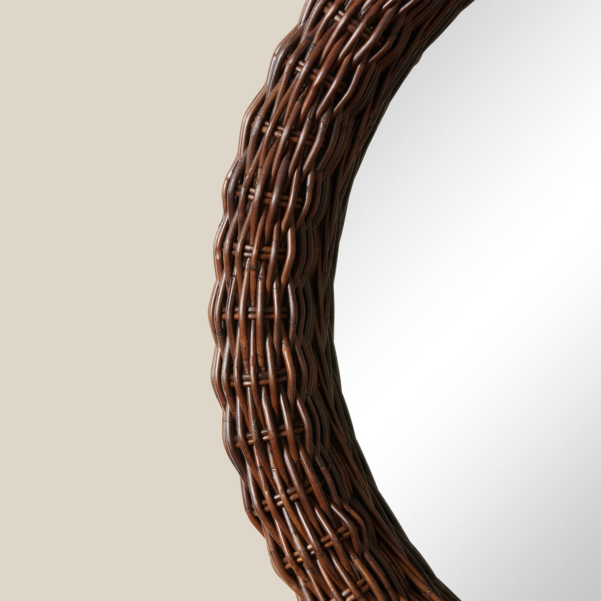 Side close up of Kingston Round Mirror 36 inch showing woven dark brown rattan frame on neutral background