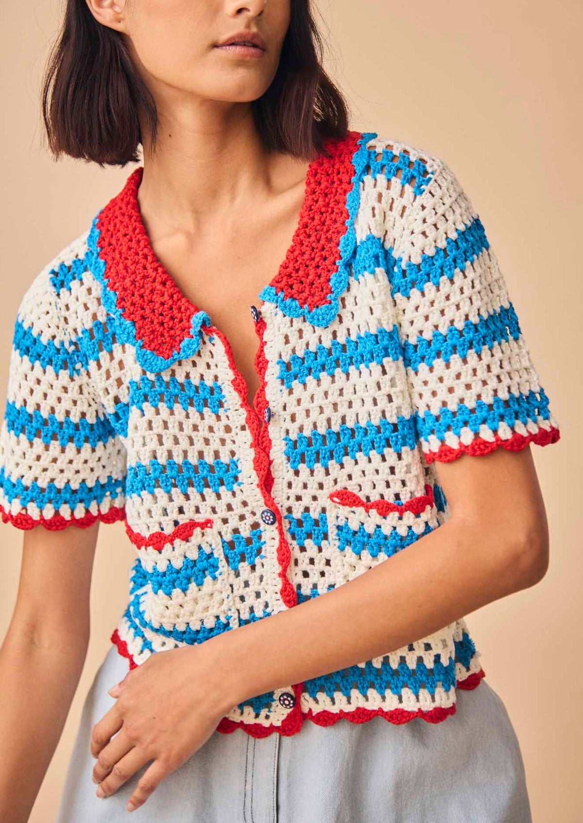 The Kate crochet Top has a contrast collar neckline, scalloped edges and colorful novelty buttons.