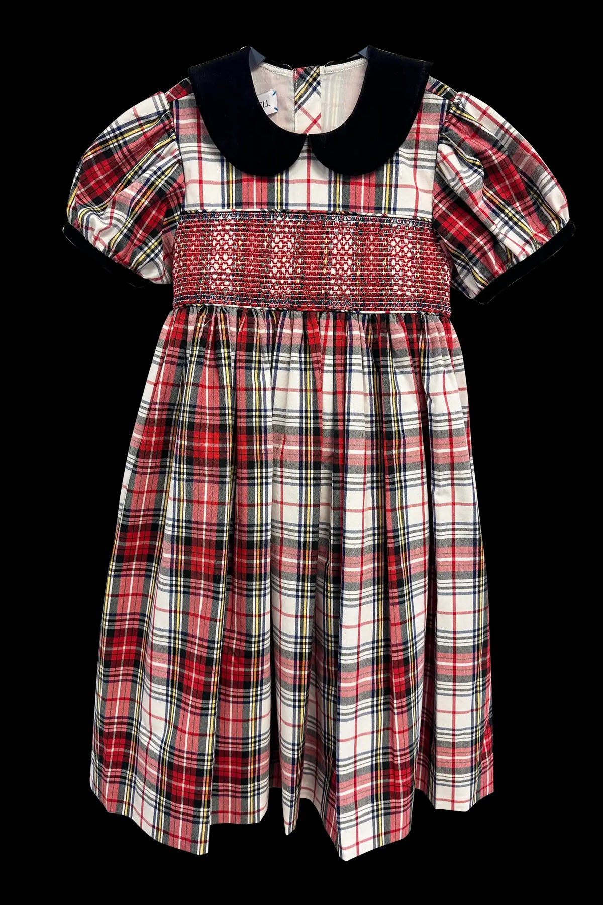 The Joy Kids Dress has a black velvet Peter Pan collar, smocked bodice, and puff short sleeves.