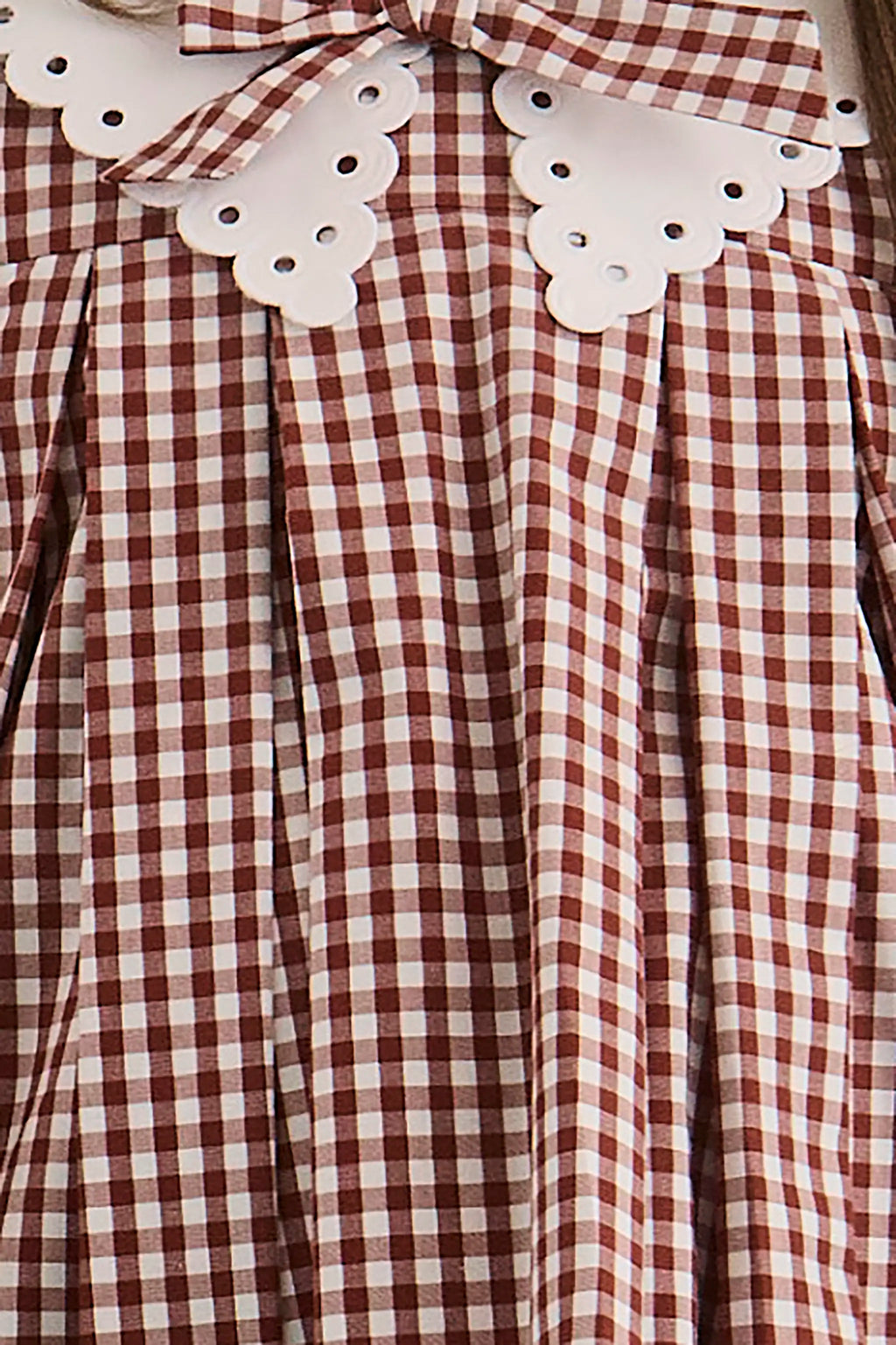 Close up of the Kids Marianne Dress in Cotswold Check Rust. 