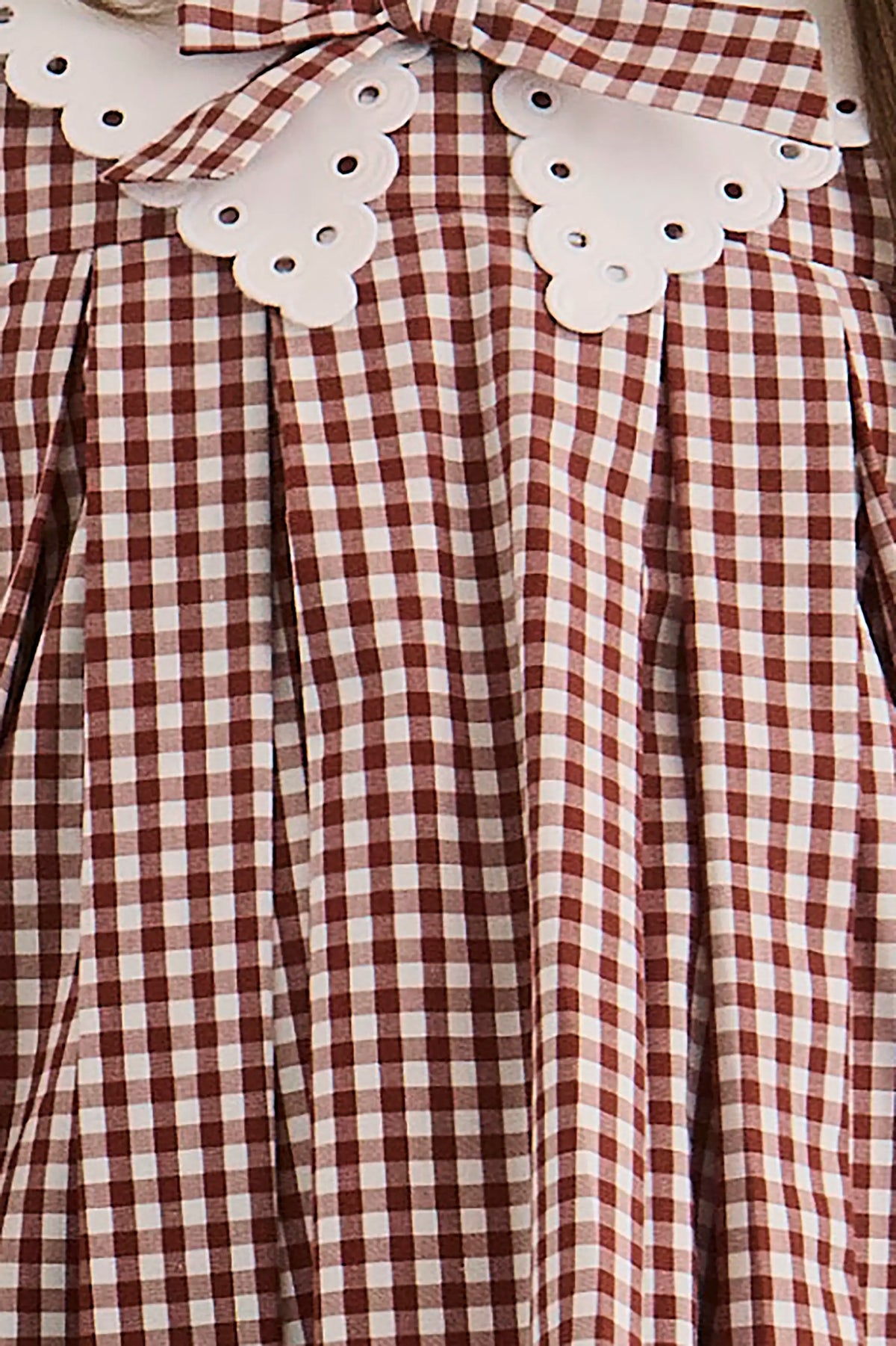 Close up of the Kids Marianne Dress in Cotswold Check Rust. 
