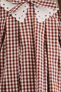 Close up of the Kids Marianne Dress in Cotswold Check Rust. 
