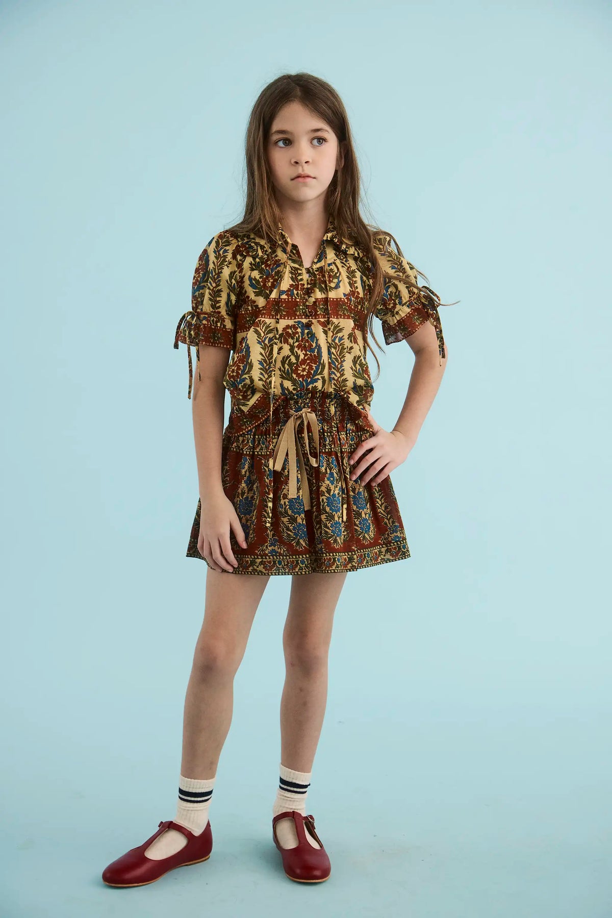 The Kids Mayfair Blouse in Amber Glen Cream paired with the Rosie Skirt in Amber Glen Brown.