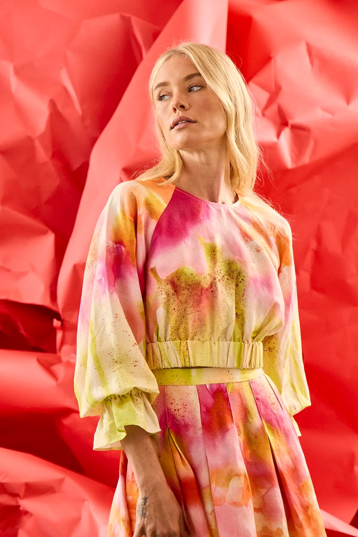 Cropped long sleeve top in yellow and pink tie-dye print with elastic at the sleeves