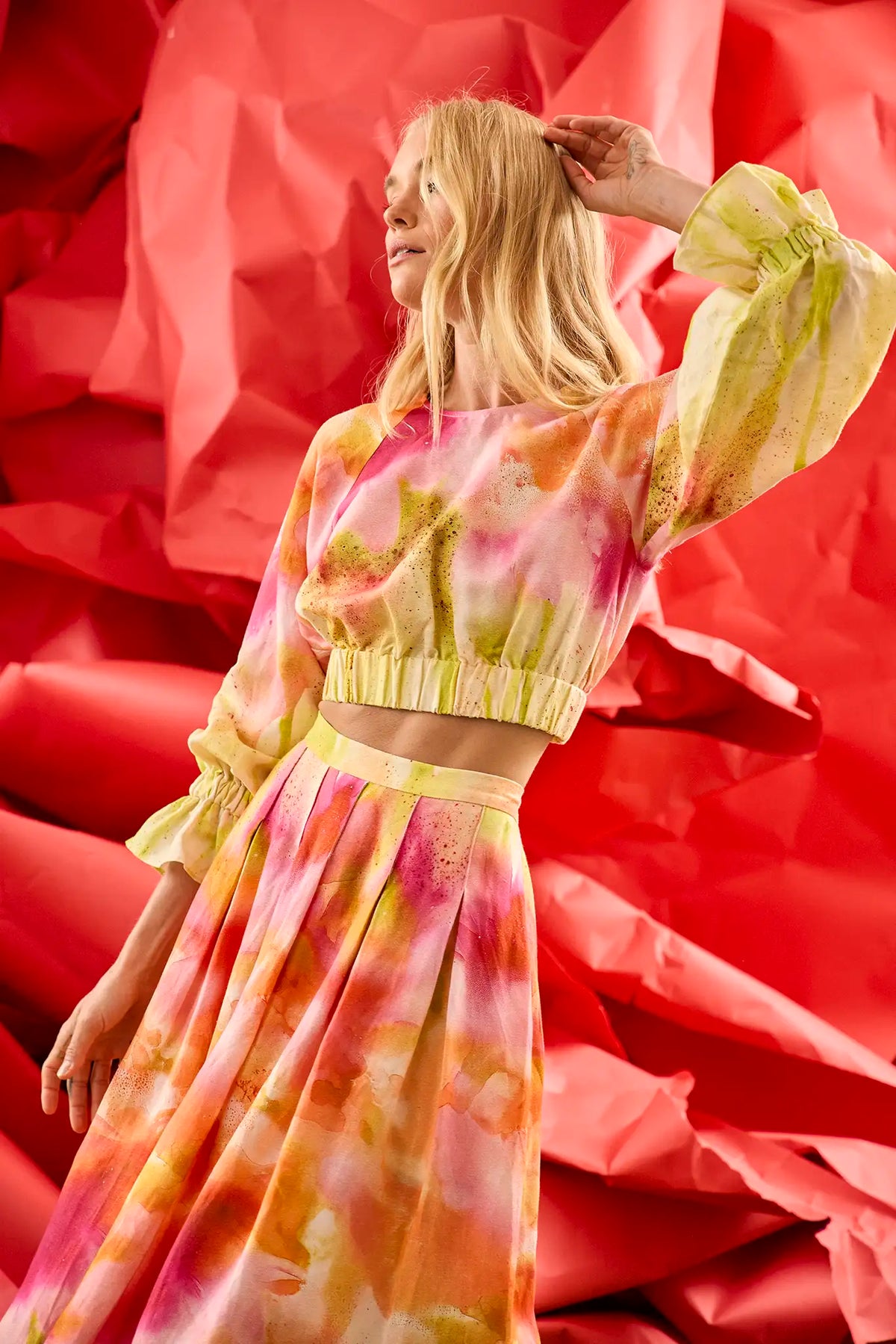 A pleated full skirt in a colorful print with a matching long sleeve top