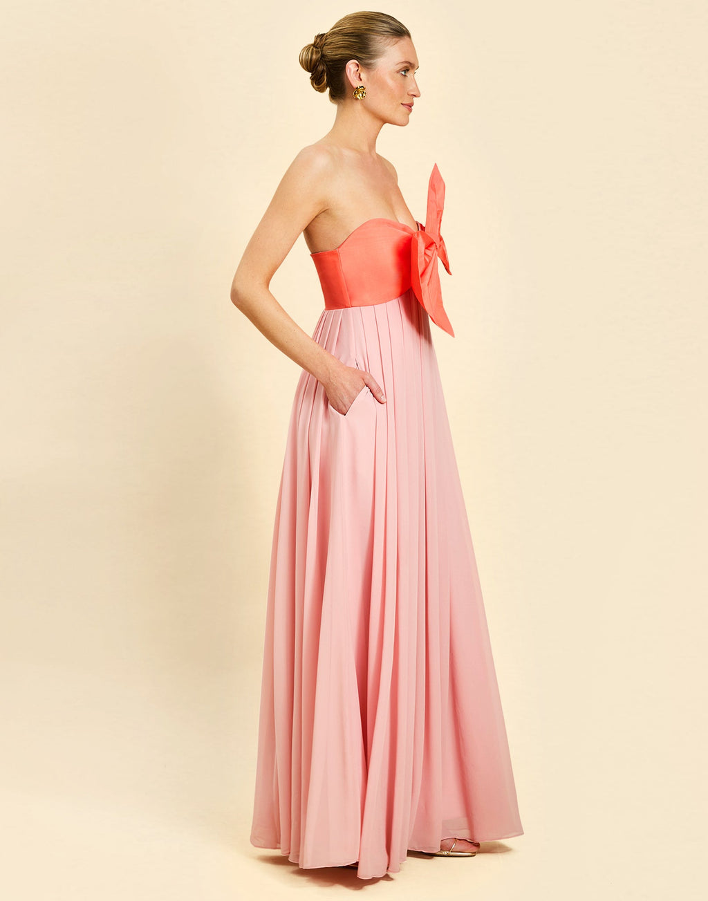 Kiss Me Knot Gown in Bloom Pink chiffon with oversized bow neckline, strapless silhouette, and flowing skirt.