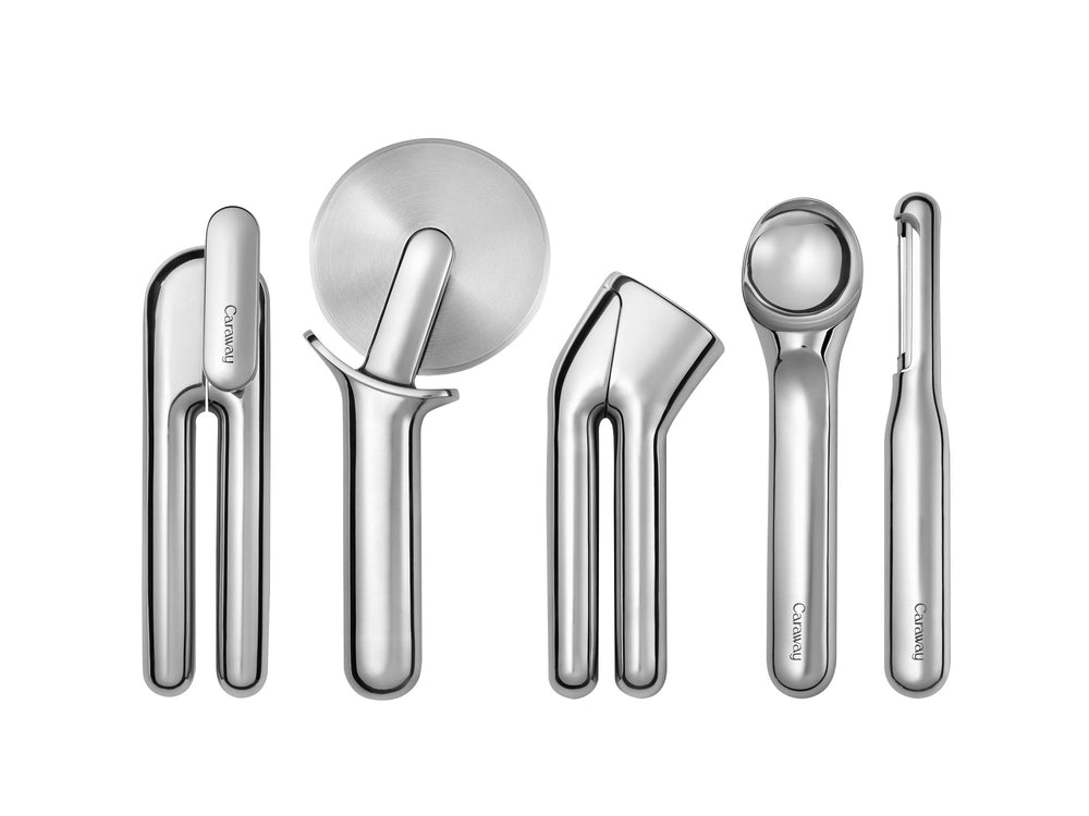 Top-down view of Caraway Kitchen Gadget Set showing five stainless tools on white background