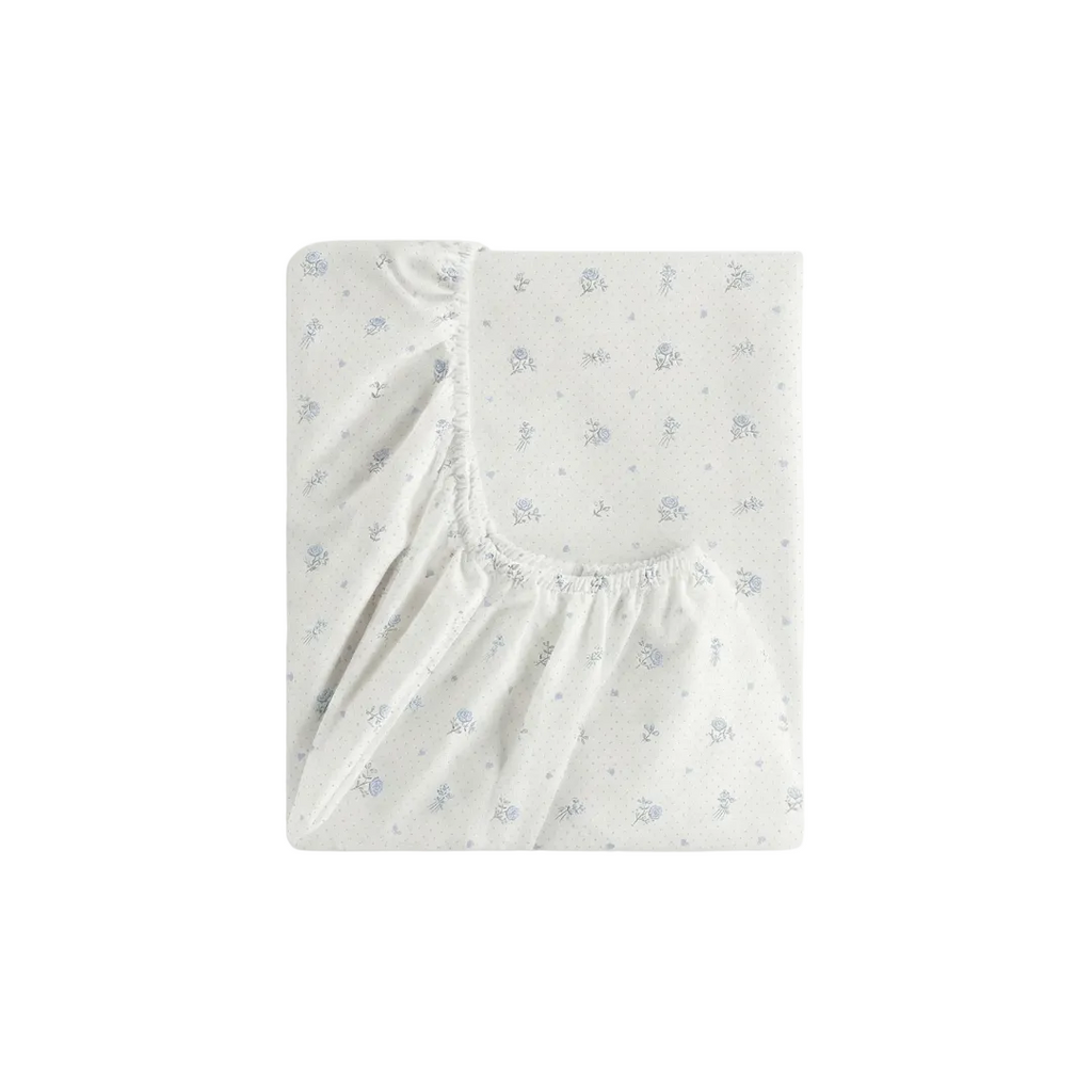 Fitted crib sheet with subtle pattern on a white background