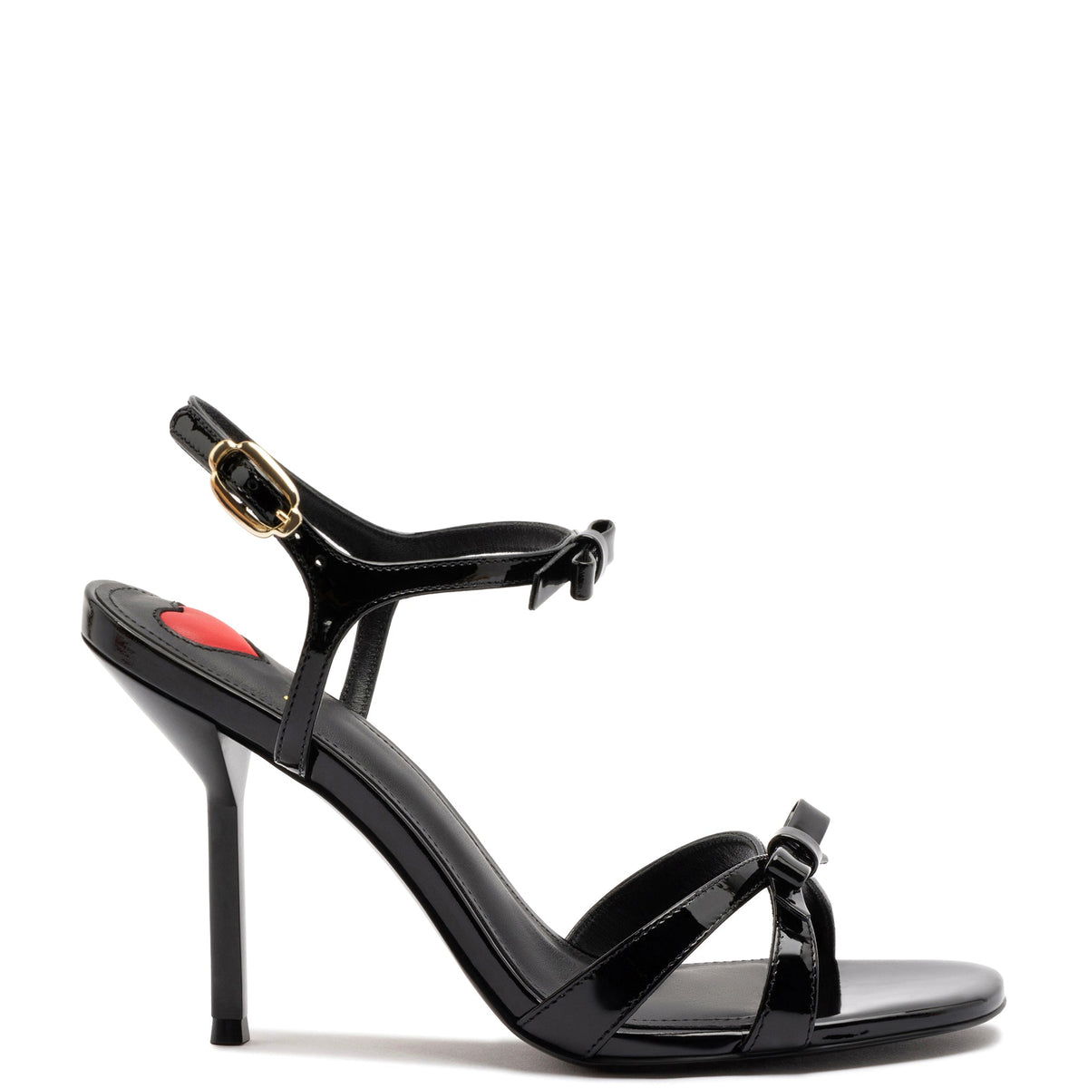Side view of Brooks Sandal In Black Patent Leather showcasing bow detail, ankle strap, open toe, and high heel with white background