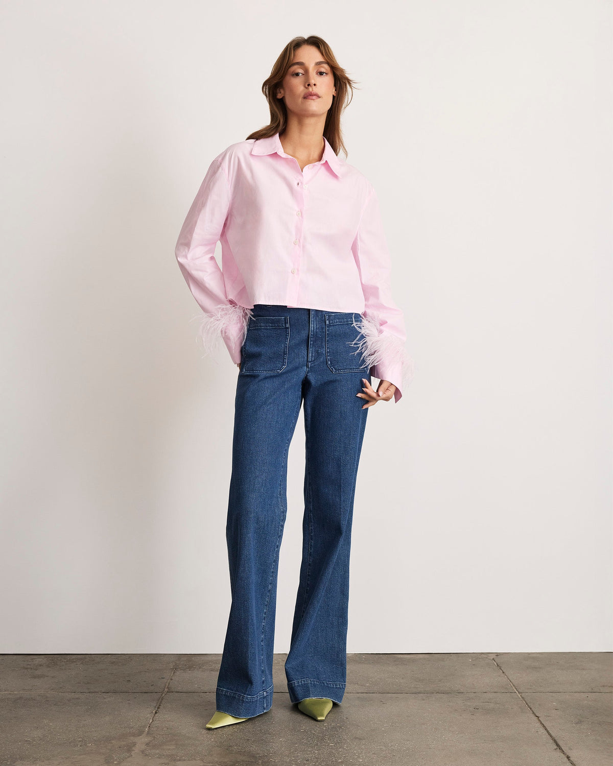 Front view of the Largaux Feather Top in Baby Pink showcasing feather-trimmed cuffs and cropped length on a model against a light background