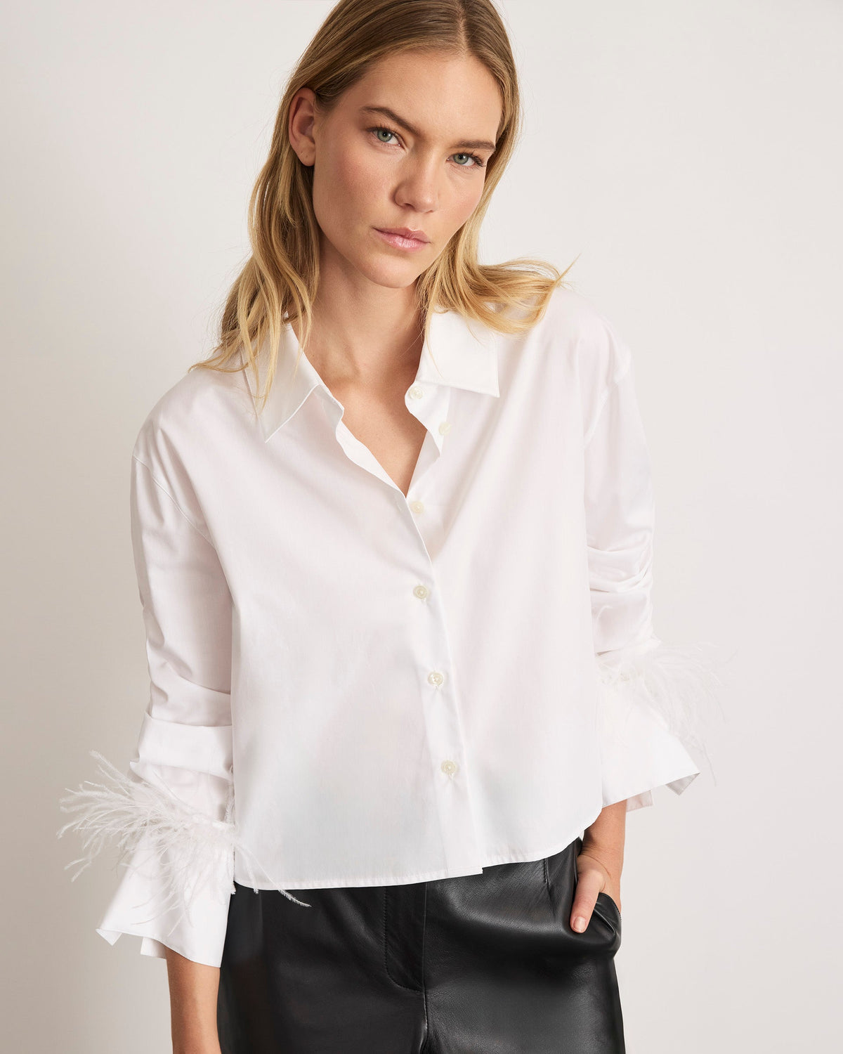 Front view of Largaux Feather Top in Optic White showcasing collared neckline and feather-trimmed cuffs against a light background