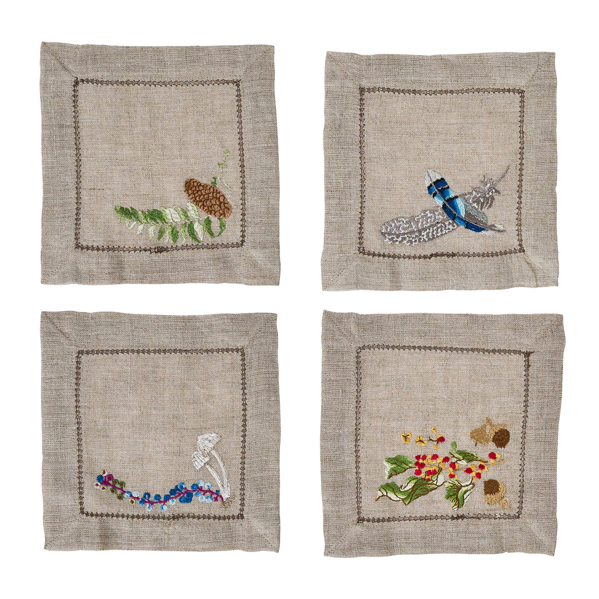 Front view of Forest Walk cocktail napkin set of four showcasing hand-embroidered woodland motifs on natural linen