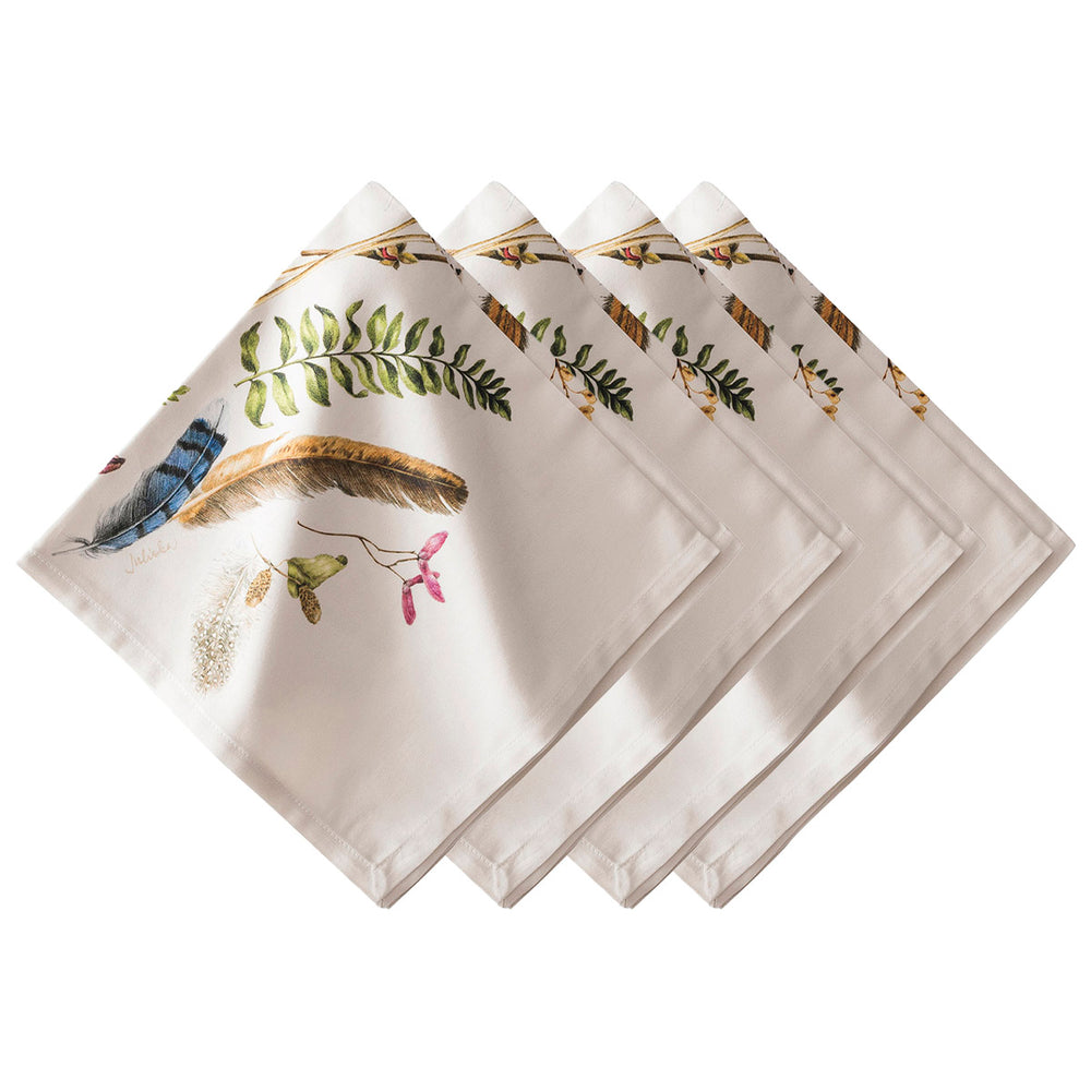 Angled view of Forest Walk linen napkins set of four showing printed feathers, leaves, and seed motifs on white background
