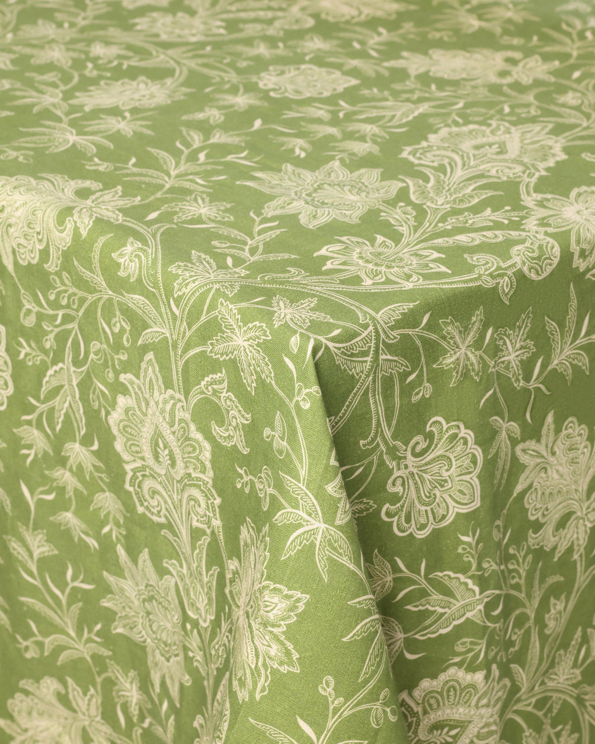 Close-up of DESTREE x Cabana Tablecloth in Green showcasing soft orange floral motif on linen fabric