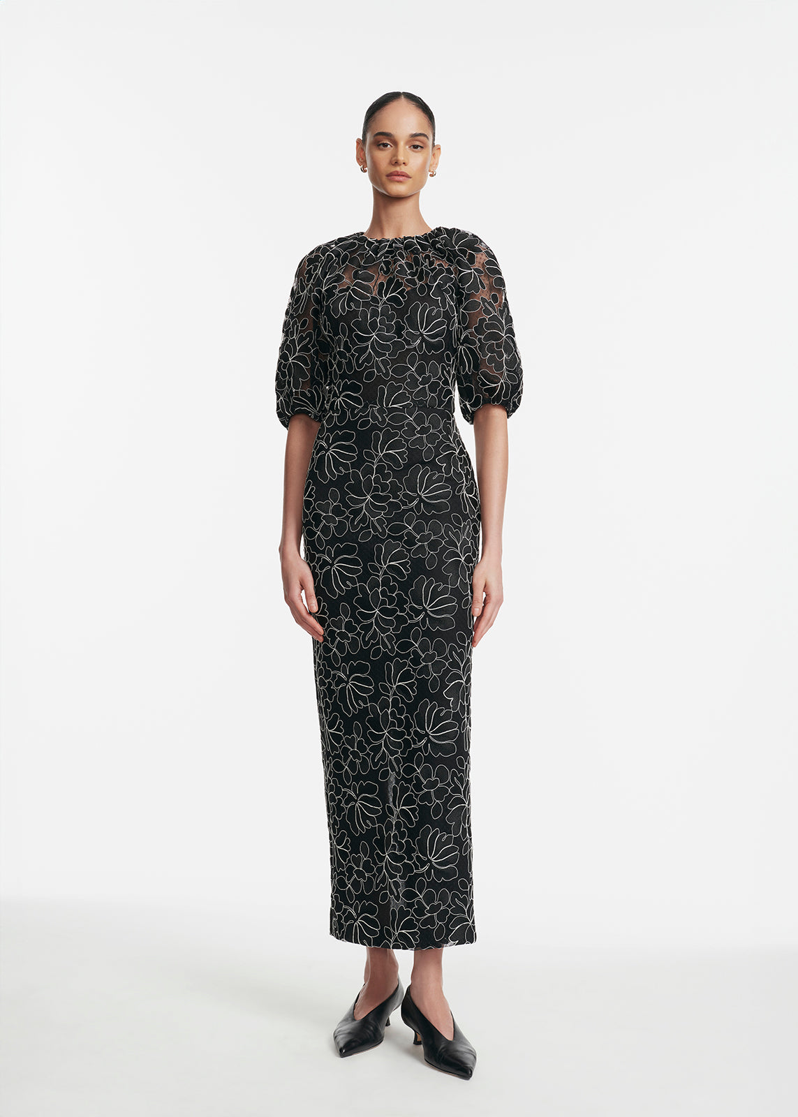 Front view of Floral Lace Naomi Dress in Black & Ivory showcasing floral lace, gathered neckline, lantern sleeves on model