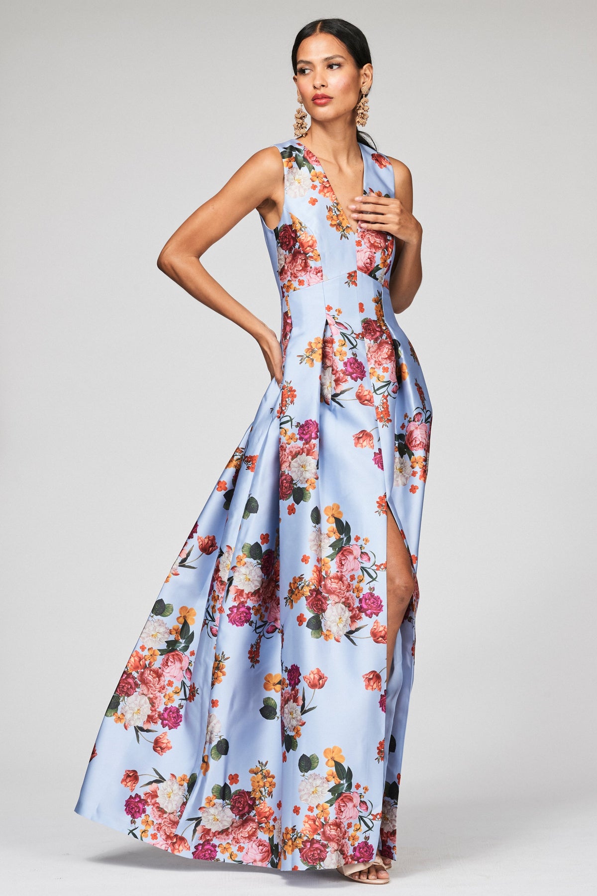 Front view of Brooke Gown Glacial Blue Bright Bouquet showcasing its V-neck and floral print on a model against gray