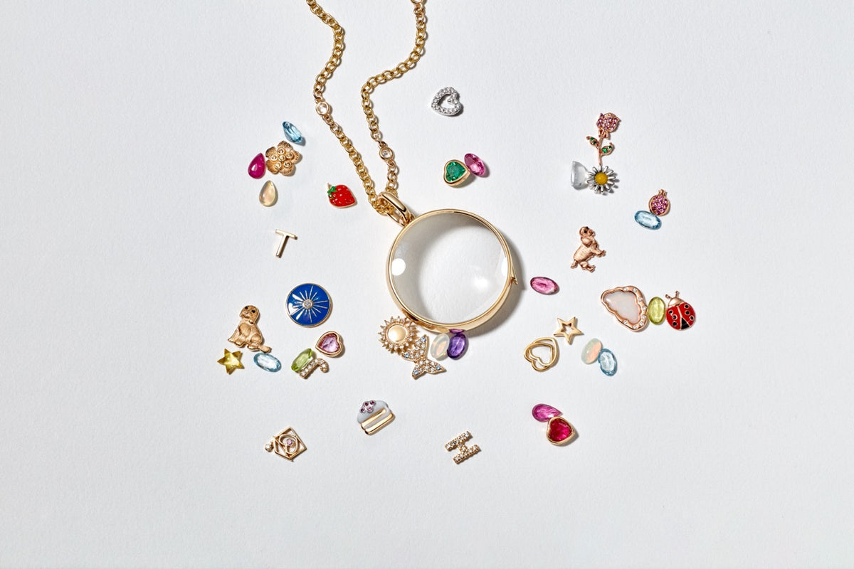 Front view of Large Round Gold Locket Pendant showcasing faceted sapphire crystal and adjustable Rolo chain with charms