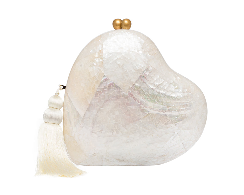 Front view of Love Clutch heart-shaped minaudière in white abalone shell mosaic with gold clasp and silk tassel