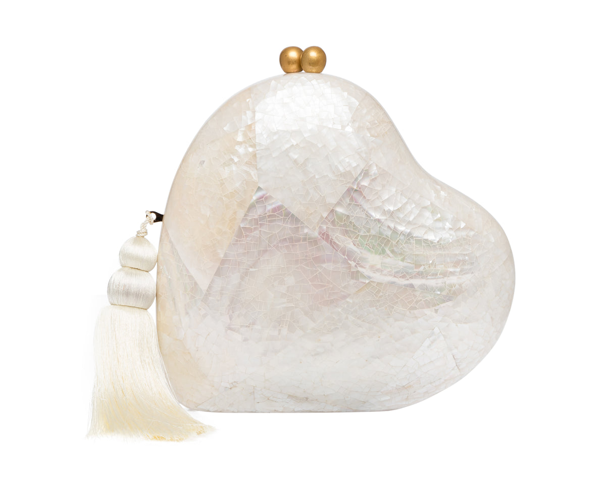 Front view of Love Clutch heart-shaped minaudière in white abalone shell mosaic with gold clasp and silk tassel