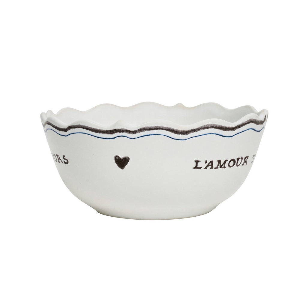 Front view of L’Amour Toujours cereal bowl with scalloped rim and black-and-blue heart and script motif on white background