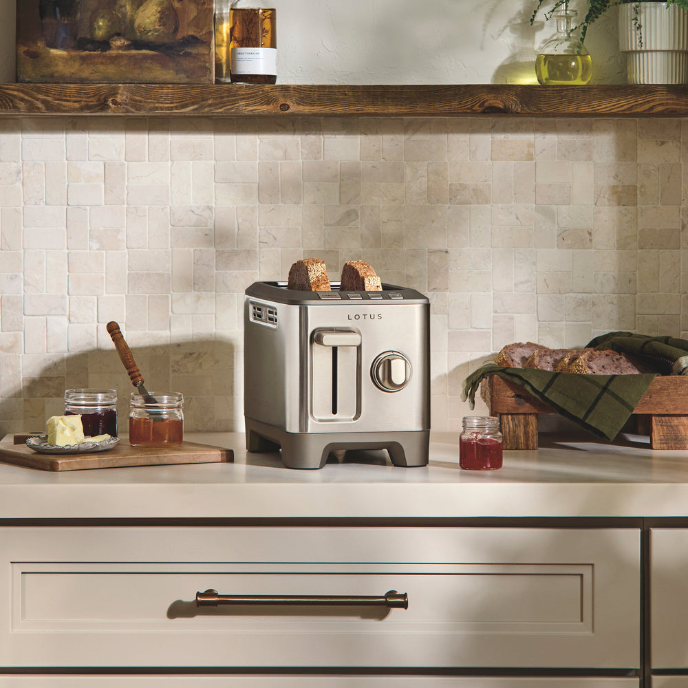 Front view of Lotus Two Slice Precision Toaster with stainless steel finish and extra-wide slots on a kitchen counter