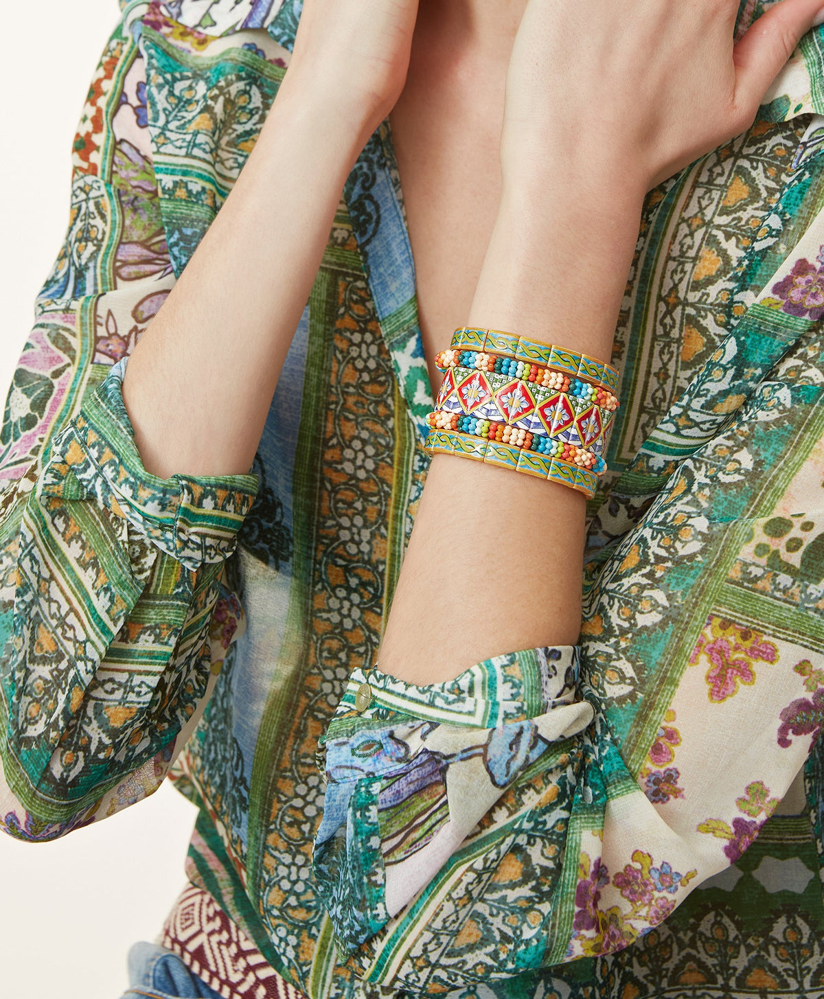Close view of The Terrazzo Bracelet with colorful mixed patterns and twisted braid on a wrist in patterned clothing