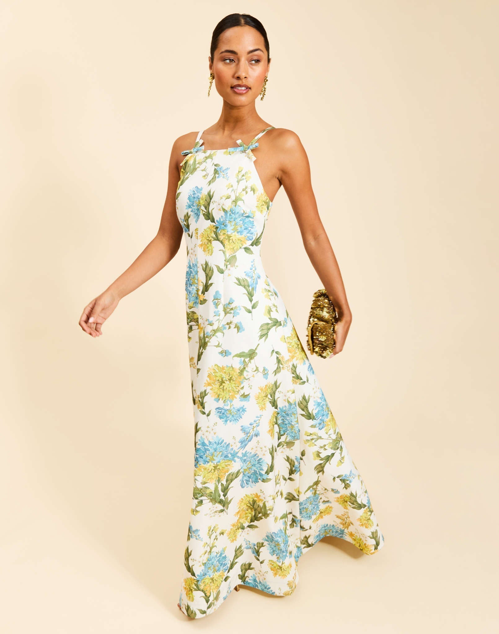Ladera Gown in Verdant Blooms poly silk twill with straight neckline, mini bow straps, A-line silhouette, and side pockets.