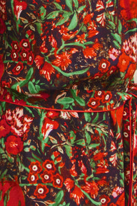 The Langley Dress is designed with a mock neck, puff sleeves, and an optional self-tie belt.