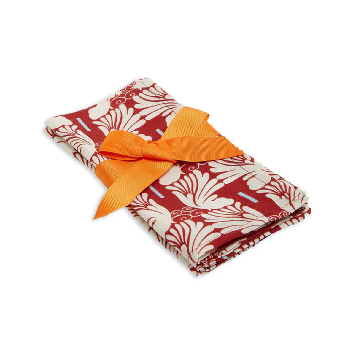 Angled view of Large Napkins in Wings Avorio Ivory, Set of 2 showcasing red and ivory print with orange ribbon on white