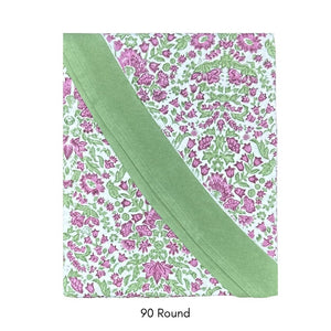 Floral patterned tablecloth with plum flowers and sage green leaves on a white background