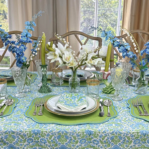 Elegant table setting with blue and green floral hand block printed tablecloth and matching napkin with greek key border and luxury embroidered placemat with decorations 