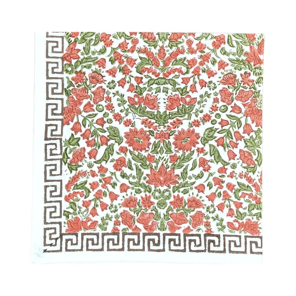 A hand block printed cloth napkin, featuring a floral pumpkin and  sage green floral pattern on a white background, finished with a Greek key border at the bottom.