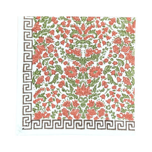 A hand block printed cloth napkin, featuring a floral pumpkin and  sage green floral pattern on a white background, finished with a Greek key border at the bottom.
