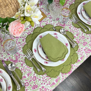 Elegant table setting with floral hand block printed tablecloth, green sage luxury embroidered placemats, and napkins and silverware.
