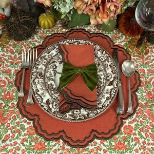 A hand block printed tablecloth, featuring a floral pumpkin and sage green floral pattern on a white background, finished with a brown band and Greek key border at the bottom, Thanksgiving tablecloth, luxury table linens