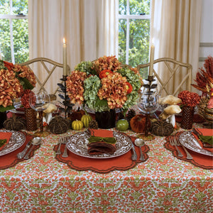 A hand block printed tablecloth, featuring a floral pumpkin and sage green floral pattern on a white background, finished with a brown band and Greek key border at the bottom, Thanksgiving tablecloth, luxury table linens