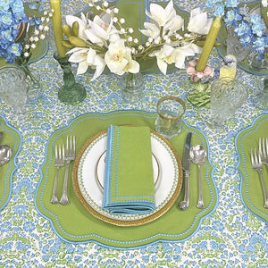 Elegant table setting with blue and green floral hand block printed tablecloth  and luxury embroidered placemat  and napkin  in green and blue with decorations 