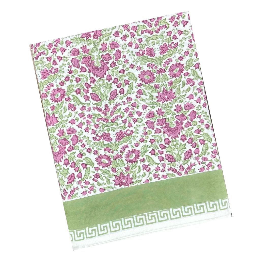 Floral patterned tablecloth with plum flowers and sage green leaves on a white background