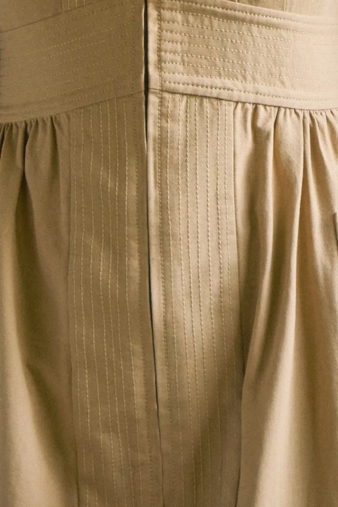 V-neck midi dress with a fitted bodice, full skirt, elbow-length sleeves finish with ties.